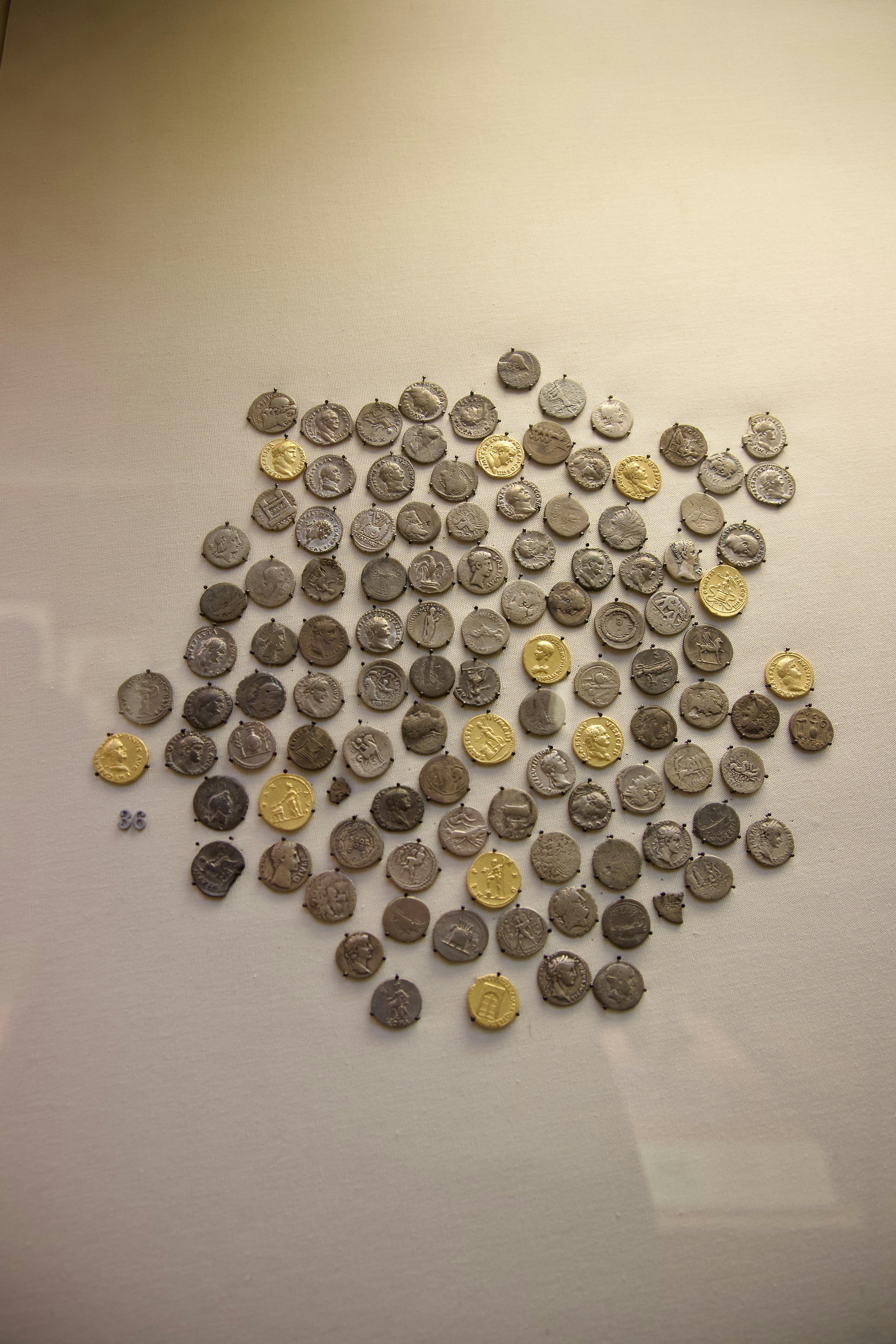 Gold and silver coins collection on dark velvet background, precious metal numismatic display