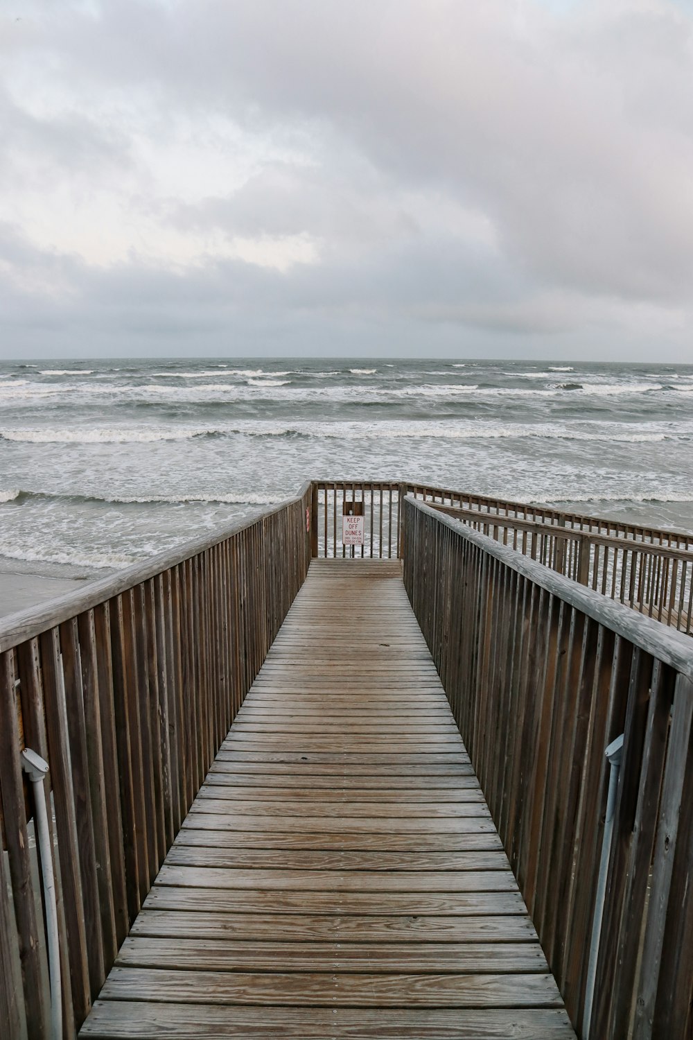 a wooden walkway leading to the beach