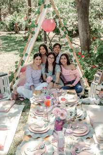 a group of people sitting around a table