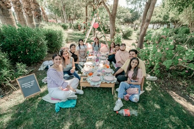 Group of diverse workers sharing a meal and smiling in a Japanese city park.