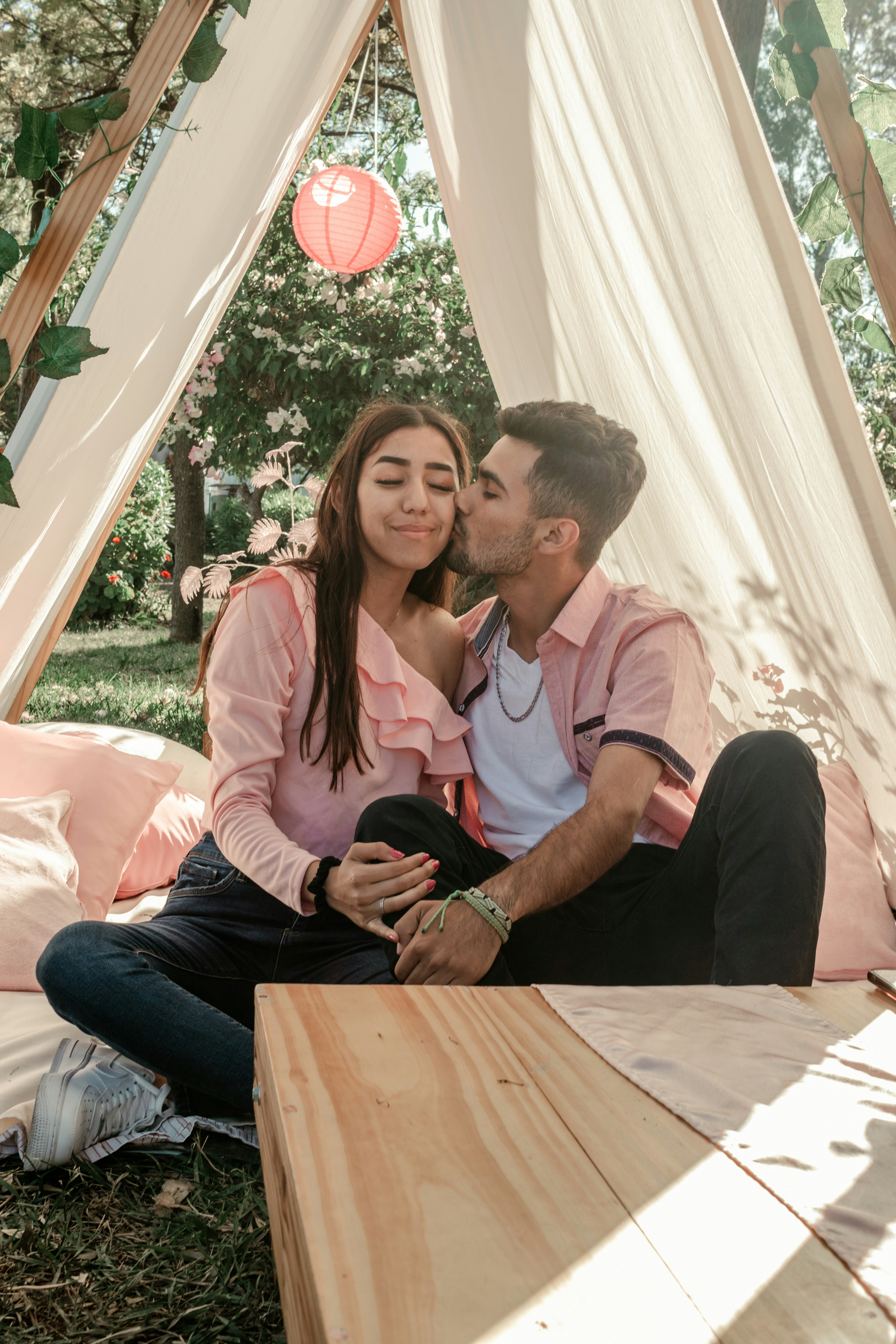 a man and a woman are sitting in a tent