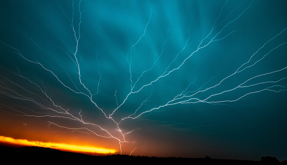 a blue sky filled with lots of lightning