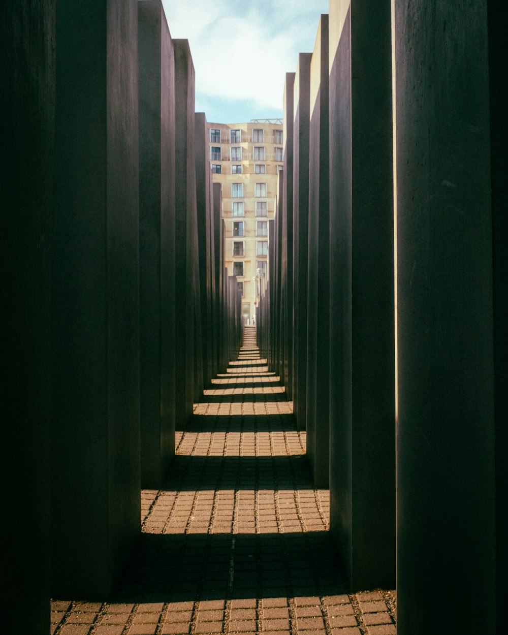 a row of concrete pillars with a sky background