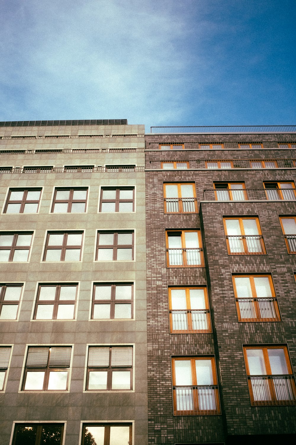 a tall building with lots of windows next to a street