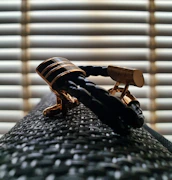 A stylish cufflink set displayed alongside a tailored blazer sleeve.