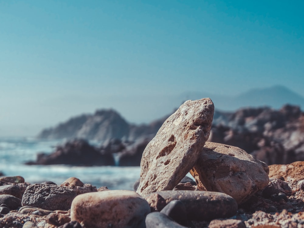 a pile of rocks sitting on top of a rocky beach