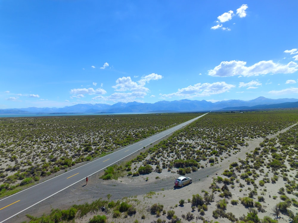 an aerial view of a road in the middle of the desert