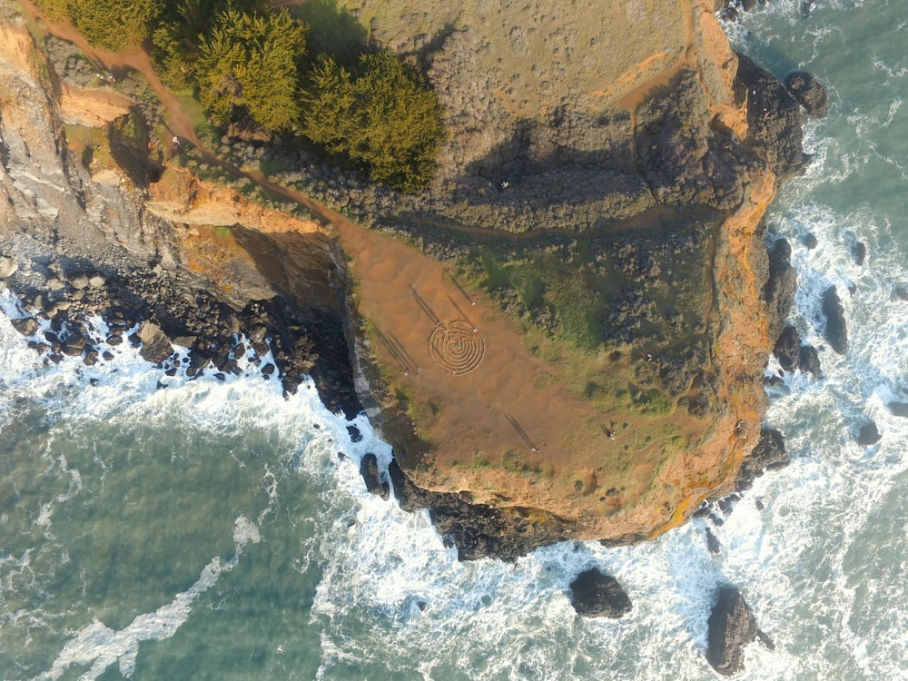 an aerial view of a beach and a cliff