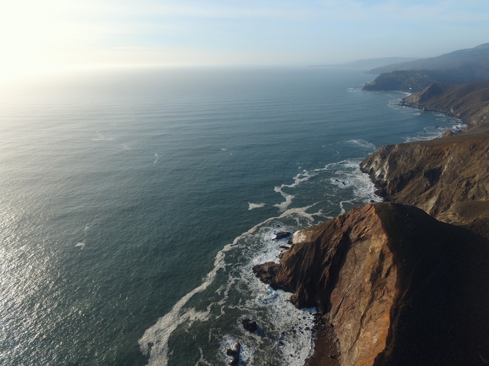 a view of the ocean from the top of a hill