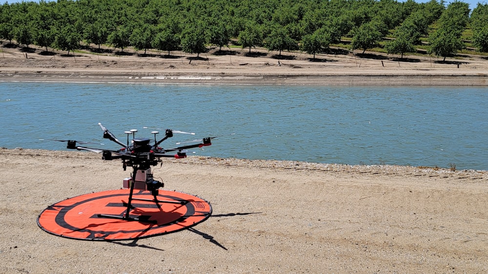 a remote controlled helicopter sitting on top of a beach