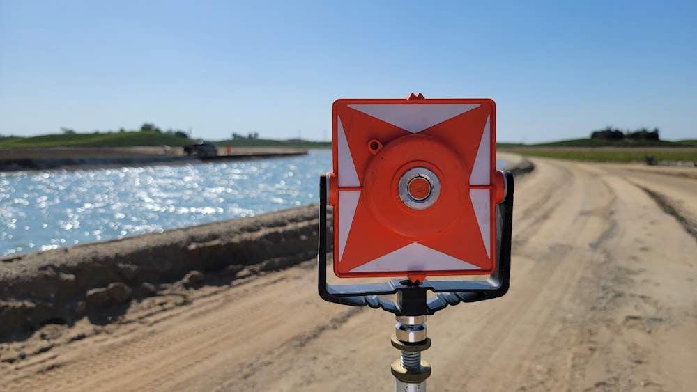 a red and white sign sitting on the side of a road