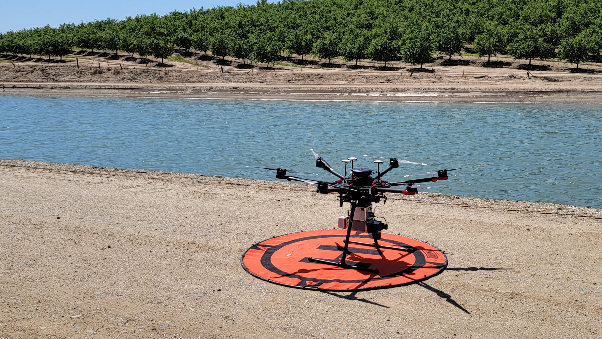 a remote controlled helicopter sitting on top of a beach