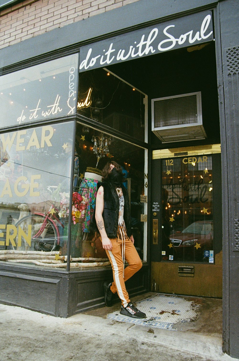 a man standing outside of a clothing store