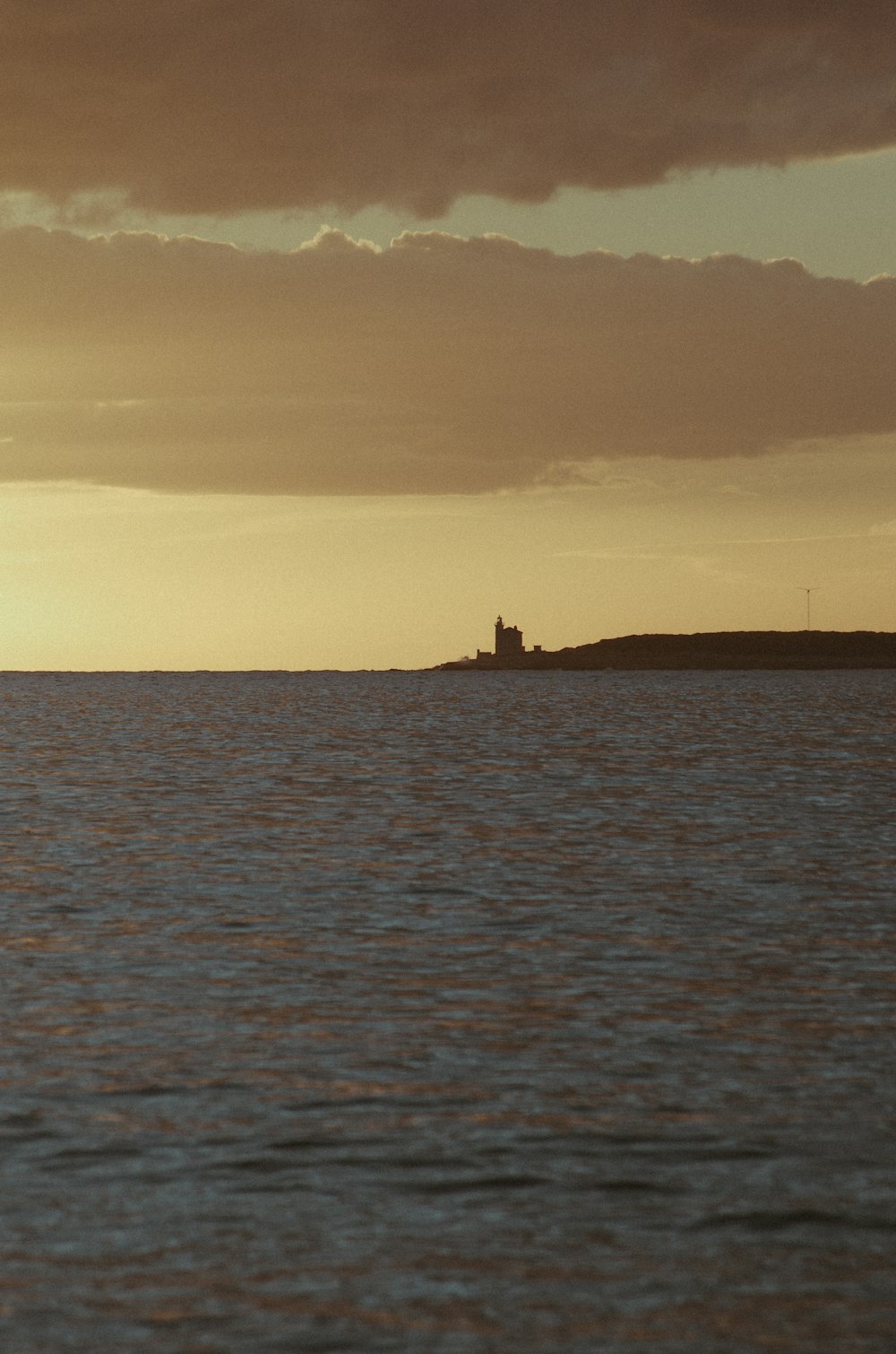 a large body of water under a cloudy sky