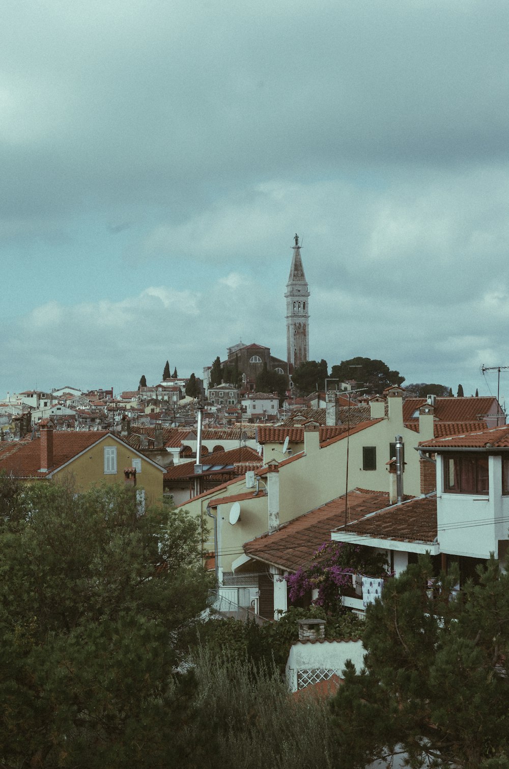 a view of a city with a clock tower in the background