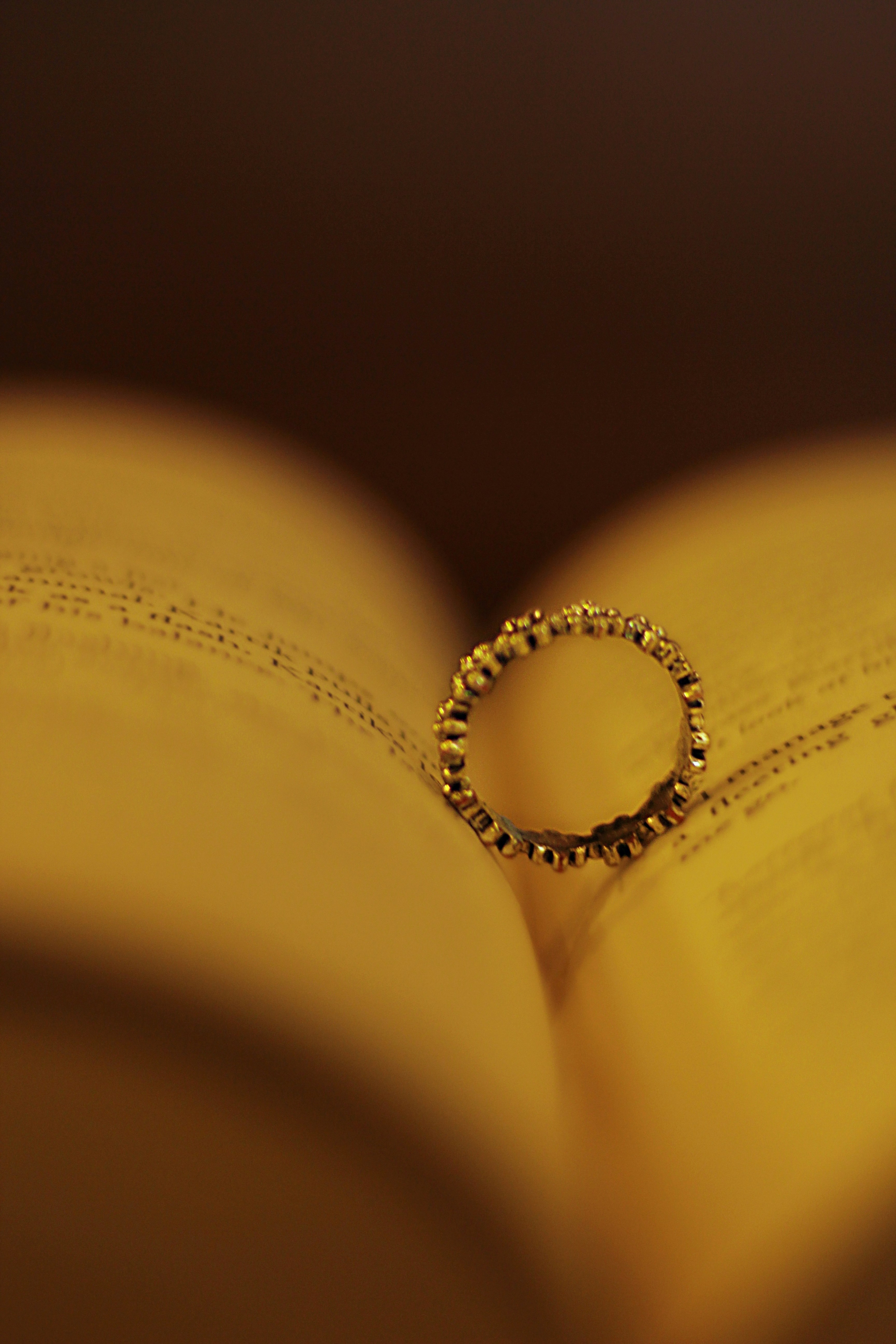 a close up of a book with a ring on it