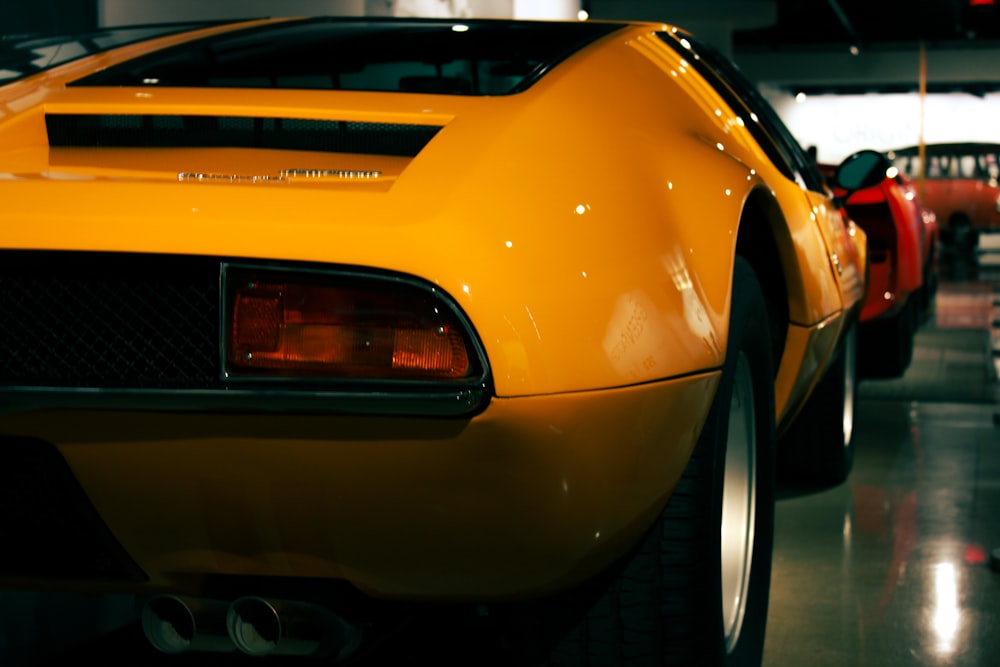 a yellow sports car parked in a garage