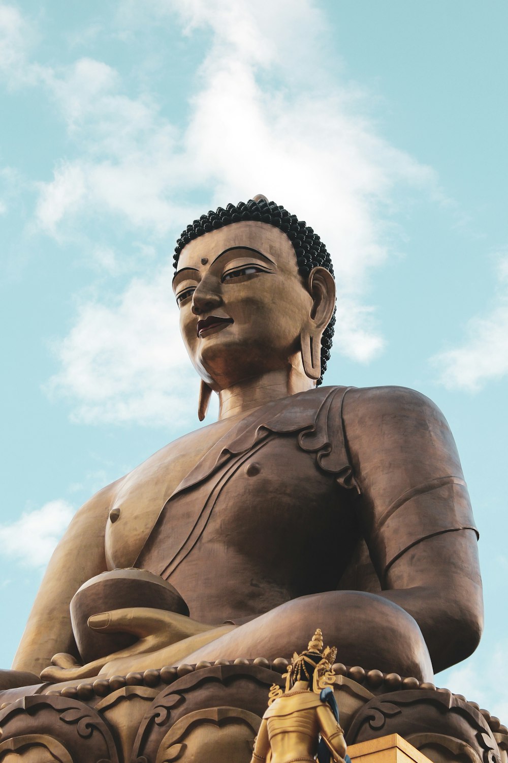 a large buddha statue sitting on top of a building