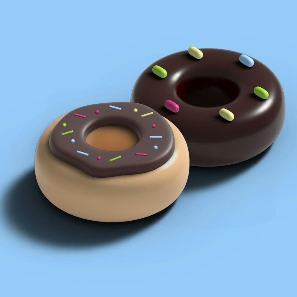 two donuts with chocolate frosting and sprinkles