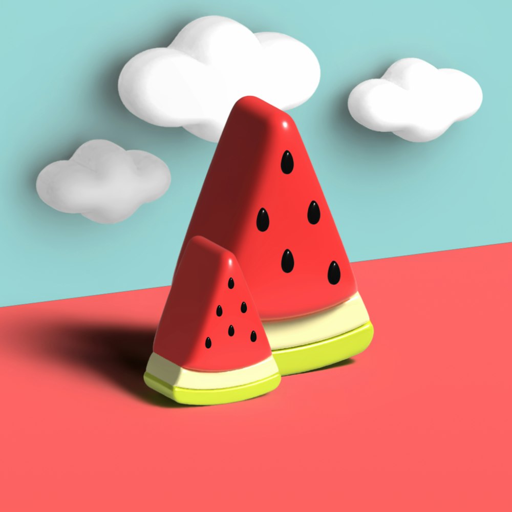 two pieces of watermelon sitting on top of a red surface