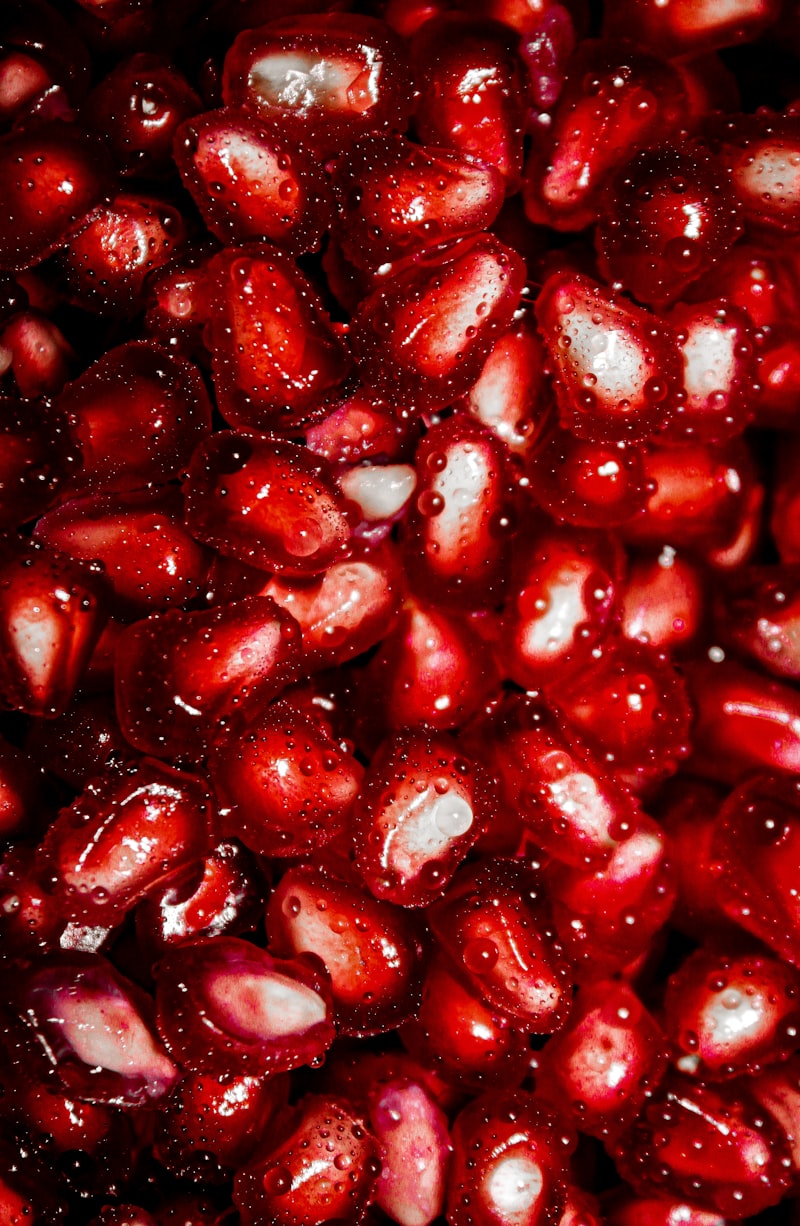 Glistening pomegranate seeds used to finish a walnut stuffed lavangi