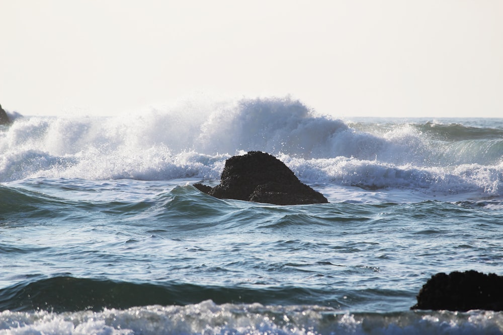 a person riding a surf board on a wave in the ocean