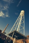 a tall white water tower sitting next to a building