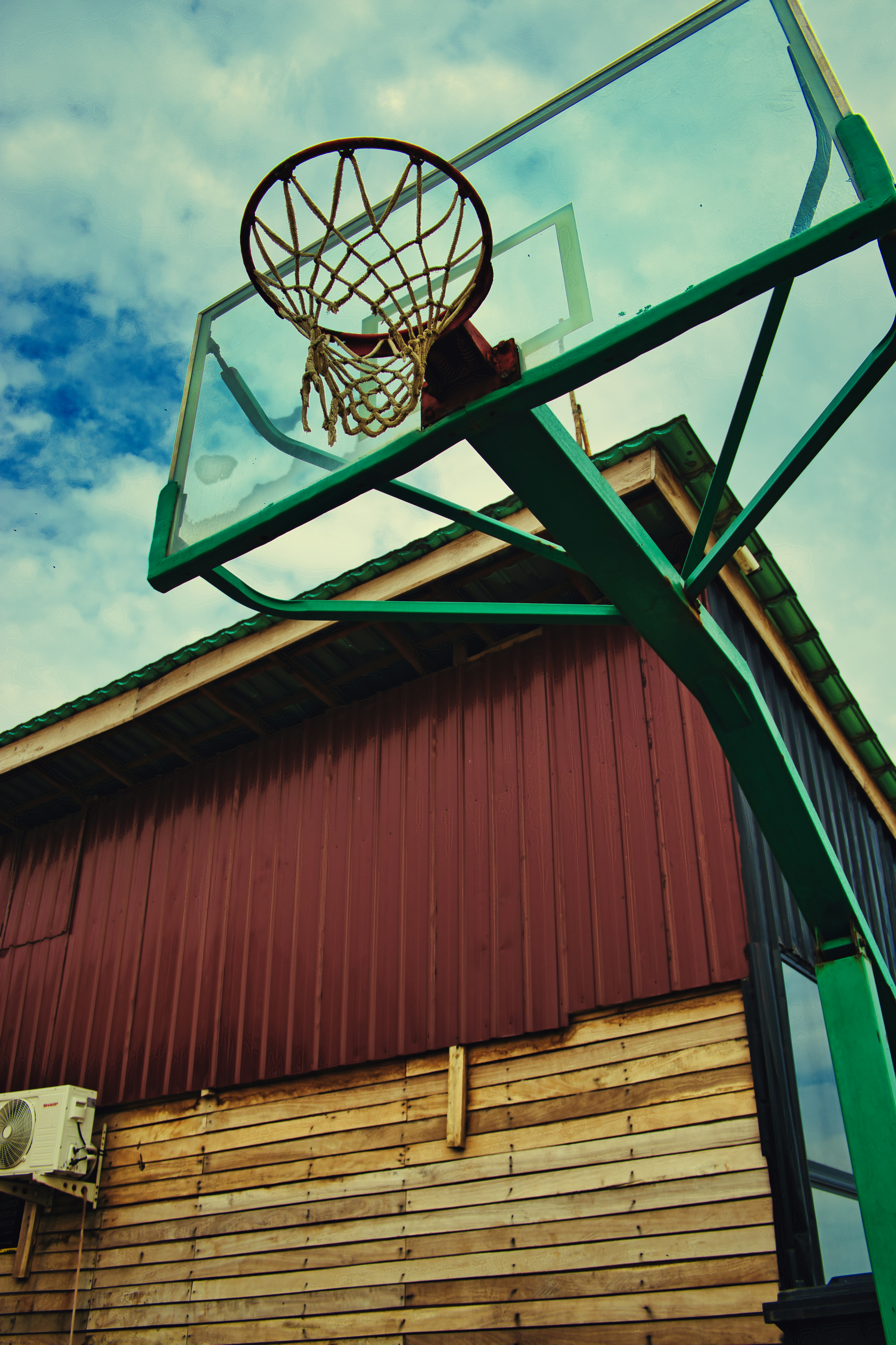 a basketball hoop hanging from the side of a building