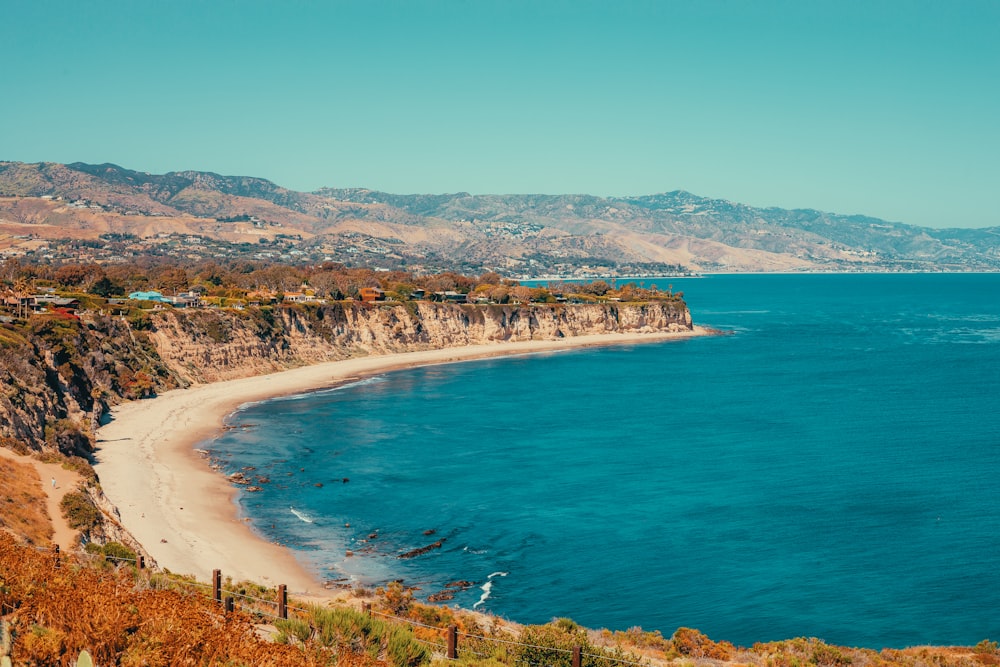 a view of a beach with a mountain in the background