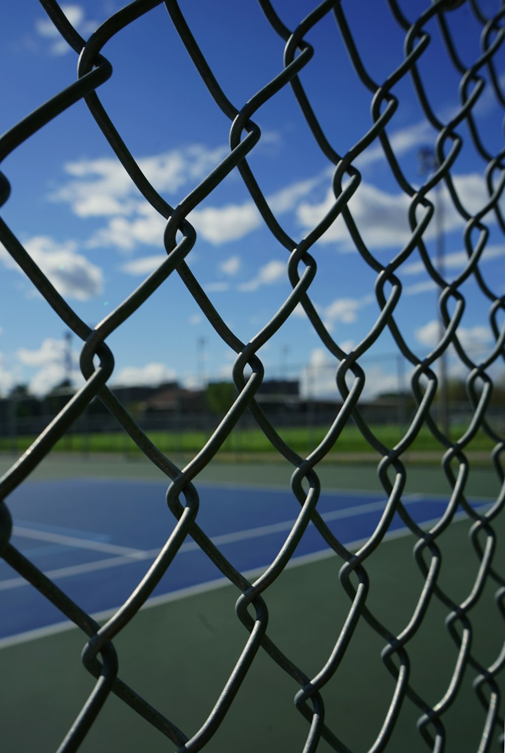 a tennis court with a chain link fence