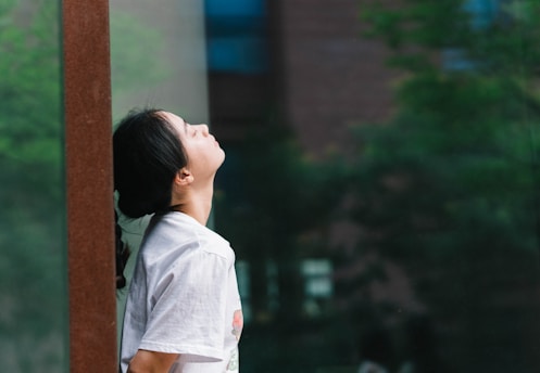 a woman is looking up into the sky
