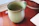 Handcrafted ceramic mug with vibrant glaze on a wooden table
