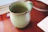 Handcrafted ceramic mug with vibrant glaze on a wooden table