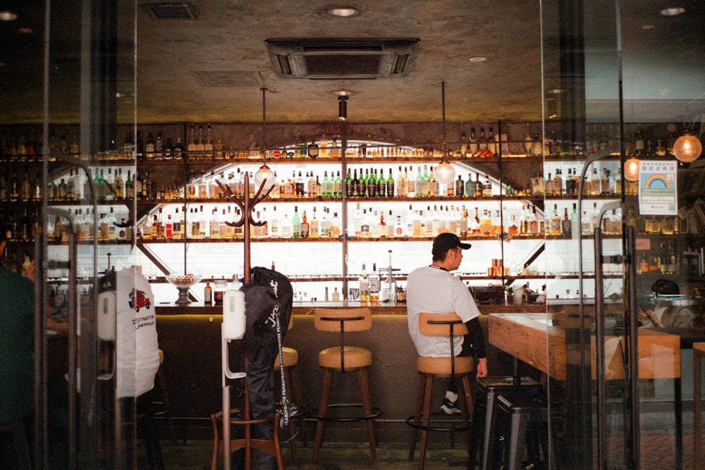 a man sitting at a bar with a back pack