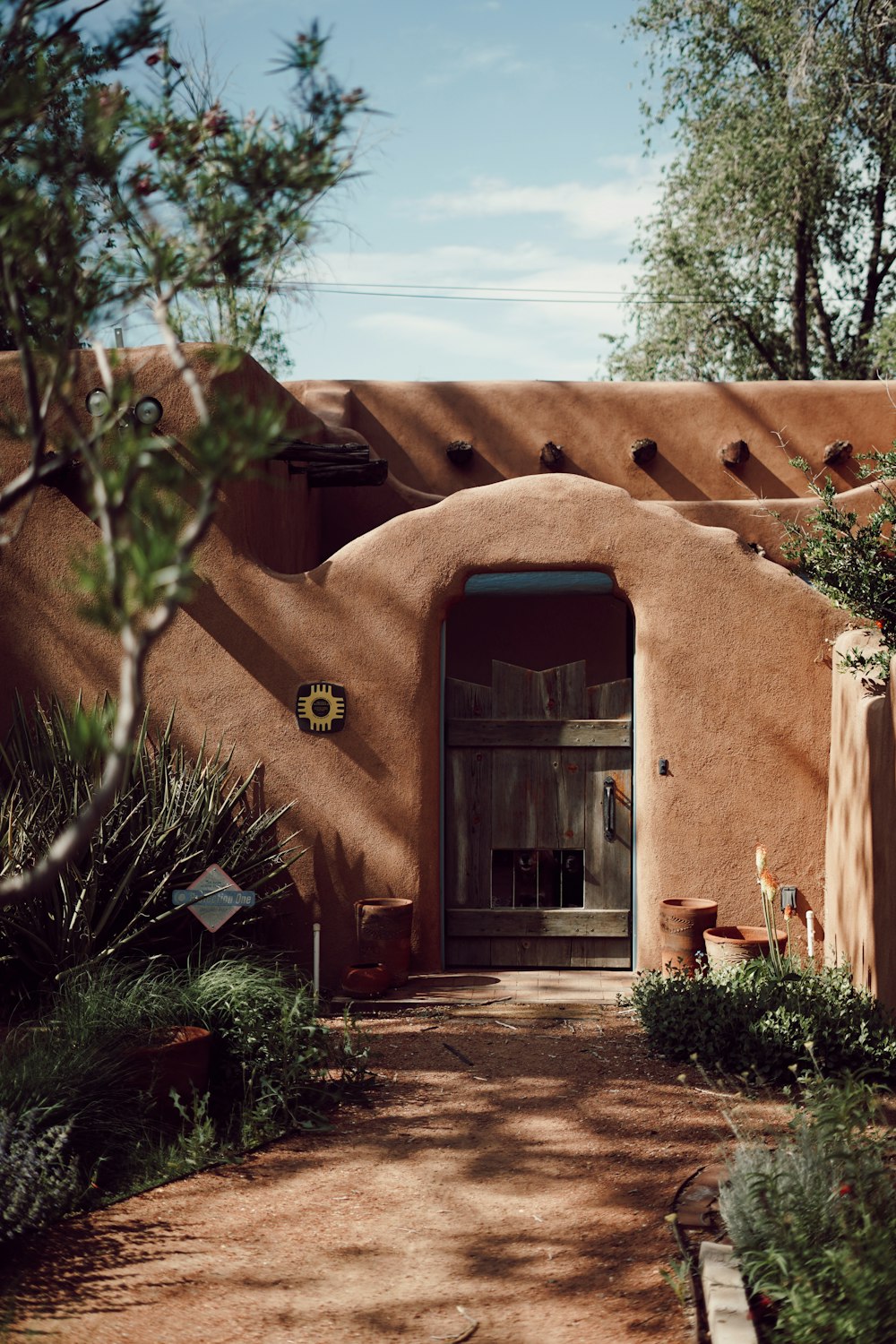 an adobe - style building with a door in the middle of it