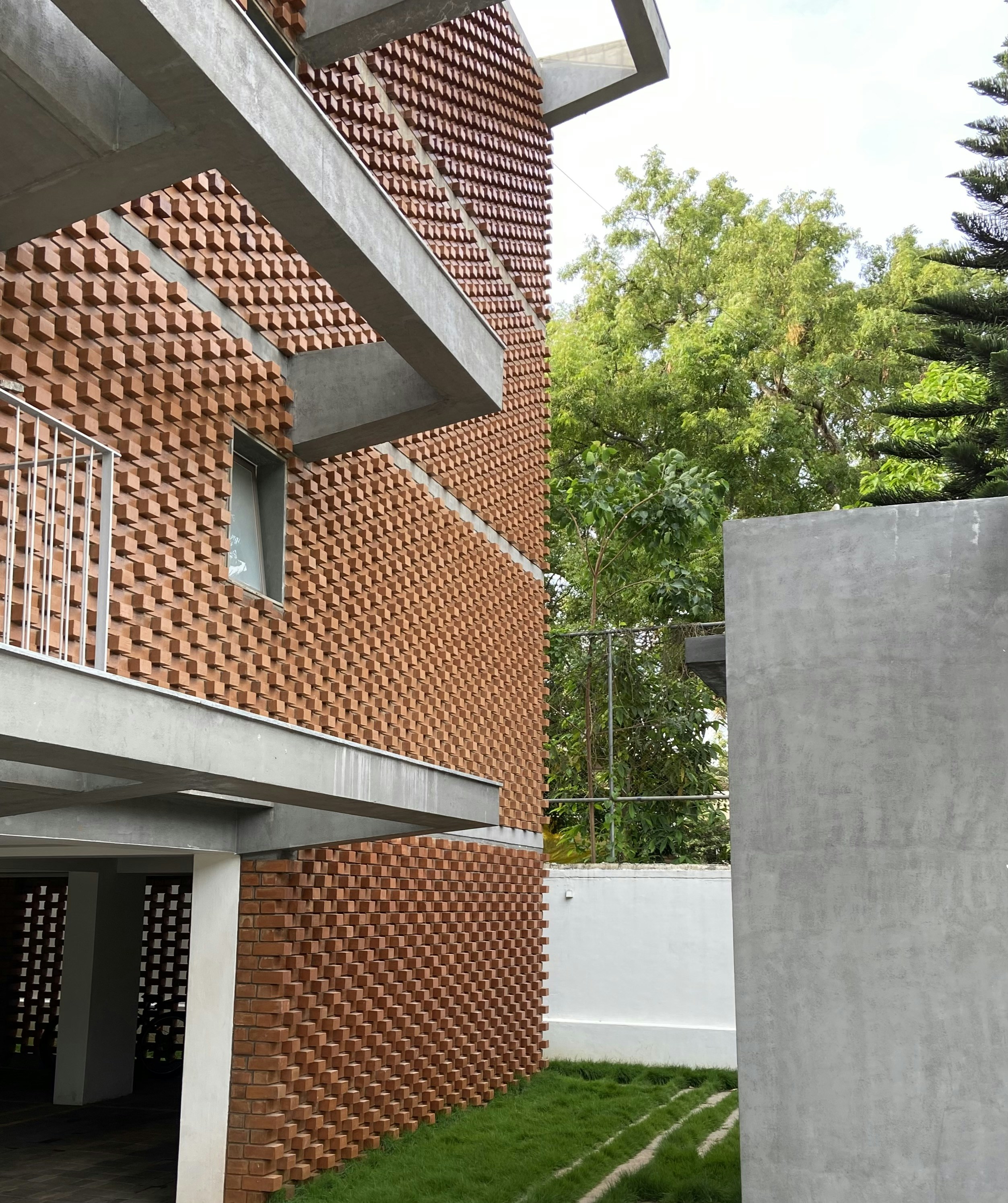 a building made out of bricks with grass in front of it