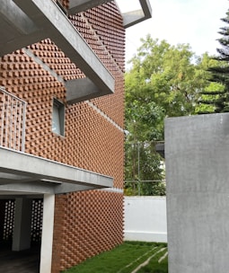 a building made out of bricks with grass in front of it