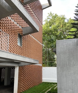 a building made out of bricks with grass in front of it