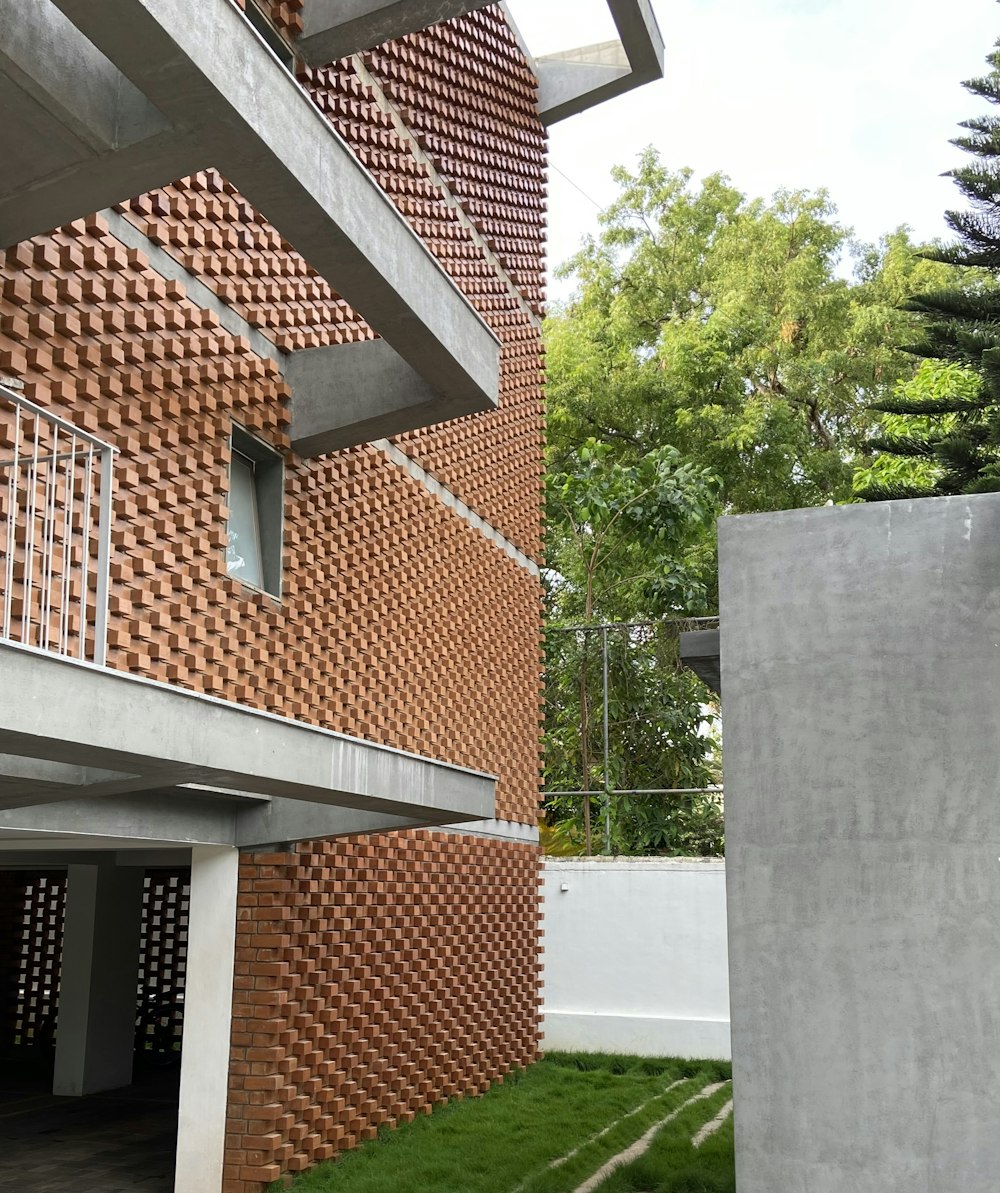 a building made out of bricks with grass in front of it