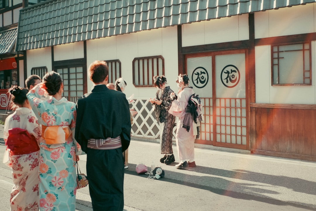 a group of people standing on the side of a road,