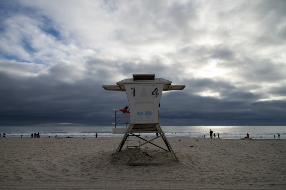 a lifeguard chair sitting on top of a sandy beach