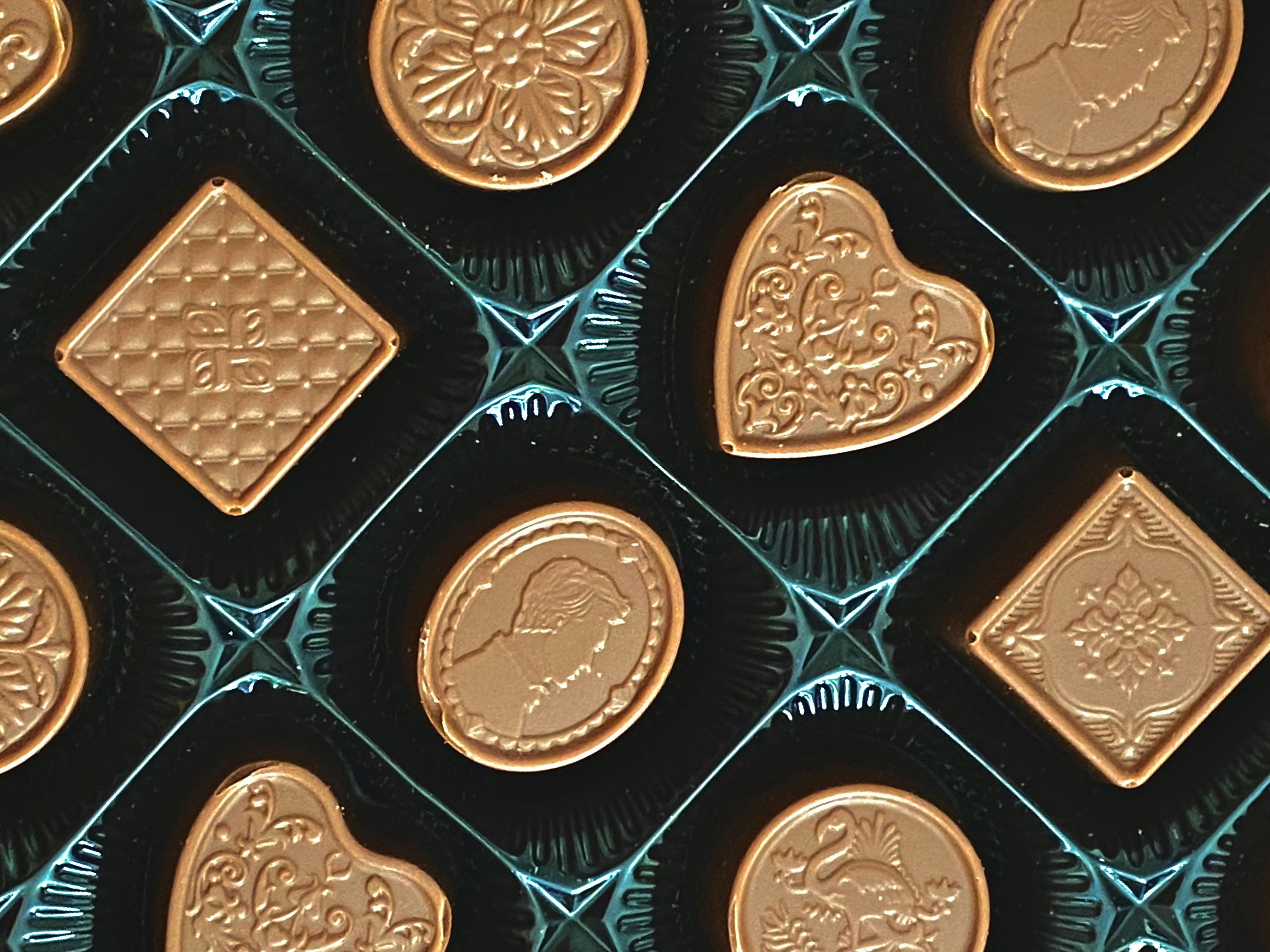 Luxury chocolate box with assorted artisan chocolates in gold foil wrappers