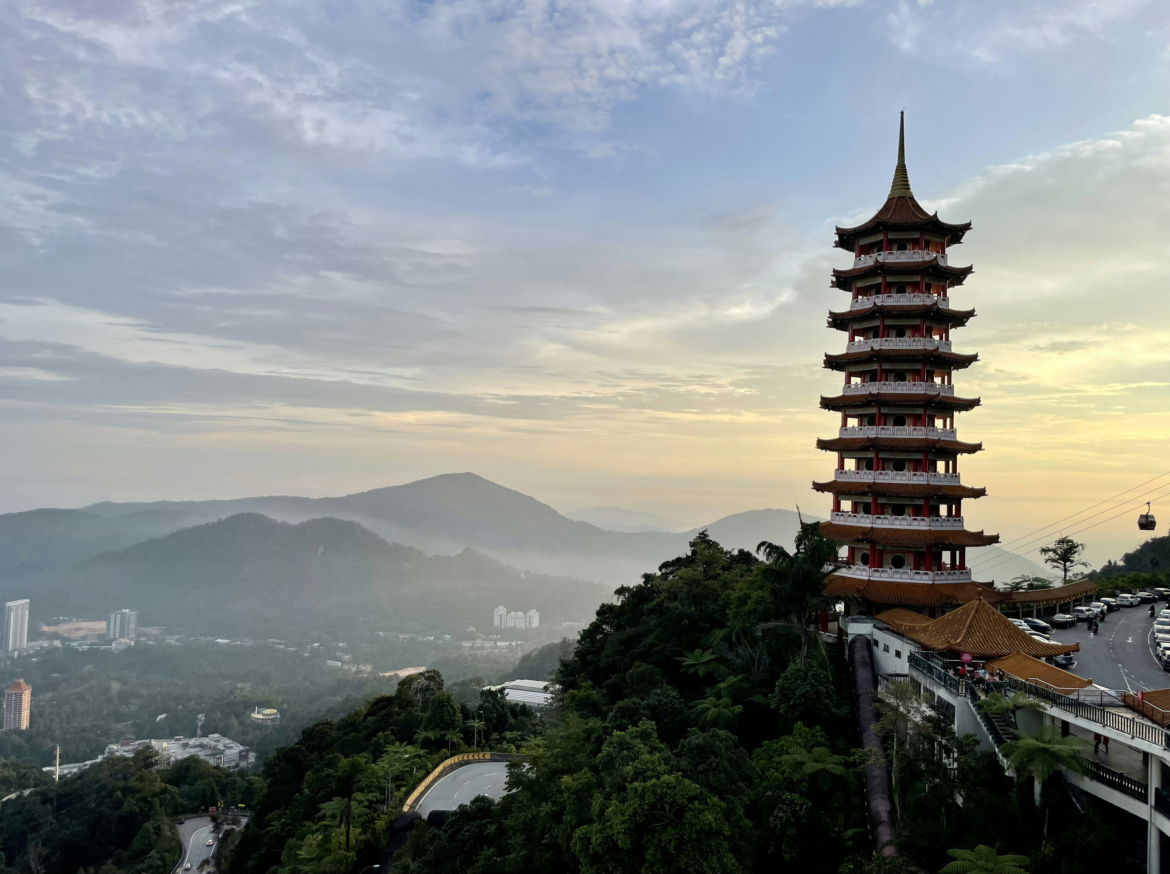 a tall tower sitting on top of a lush green hillside