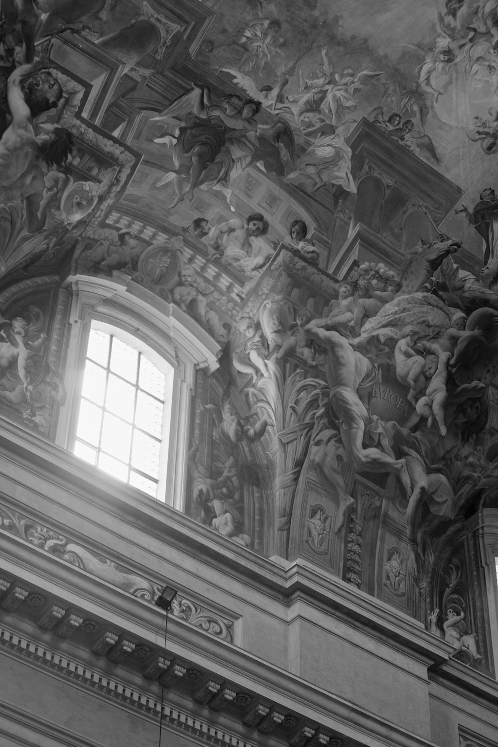 the ceiling of a building with many paintings on it