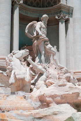a statue of a man riding a horse in front of a building