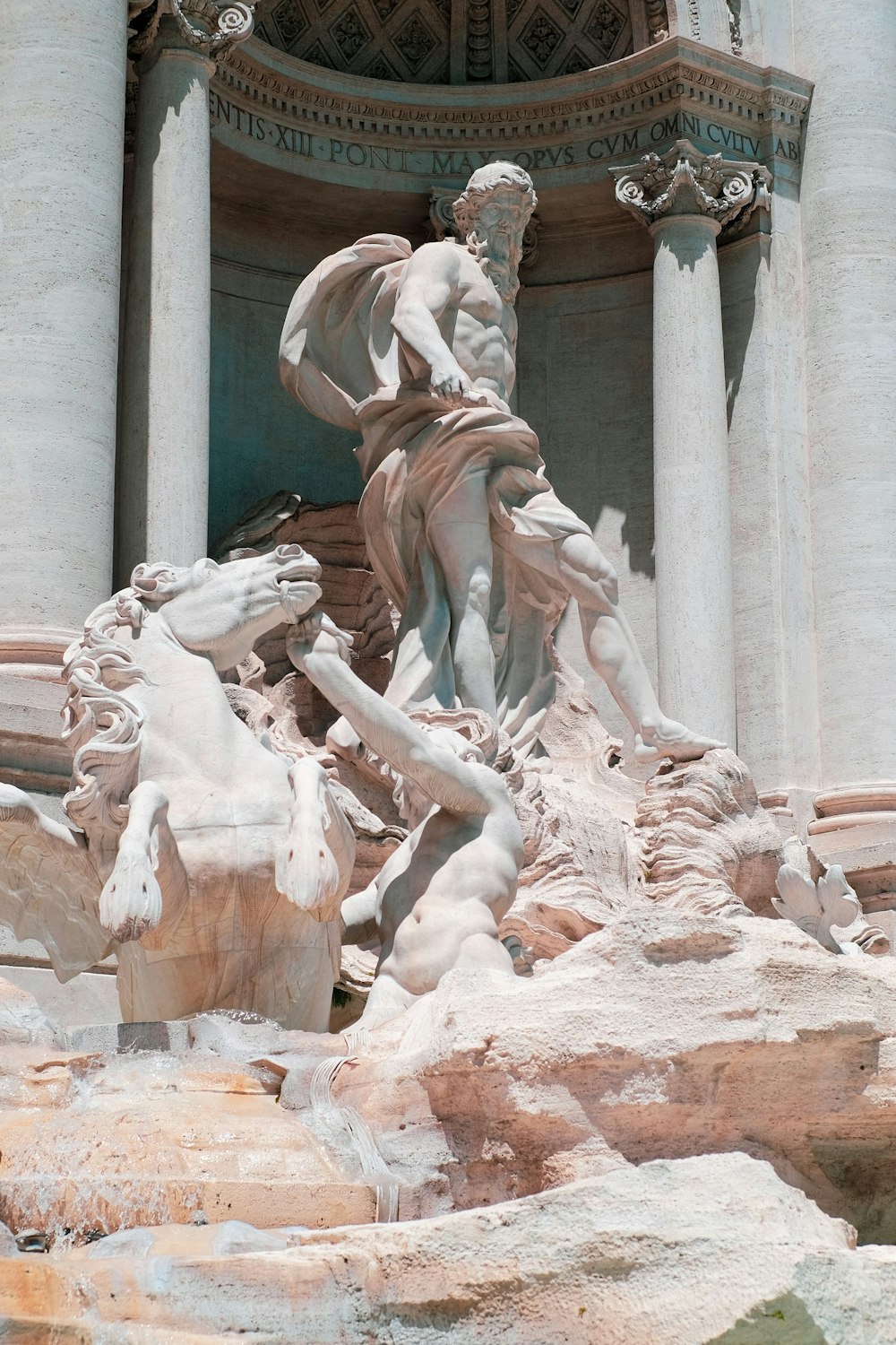 a statue of a man riding a horse in front of a building