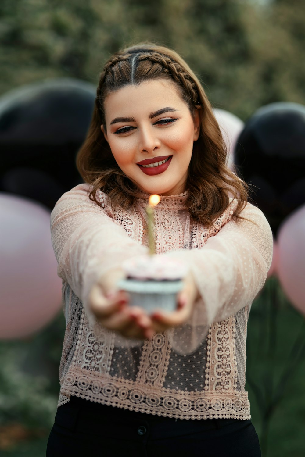 a woman holding a candle in her hand