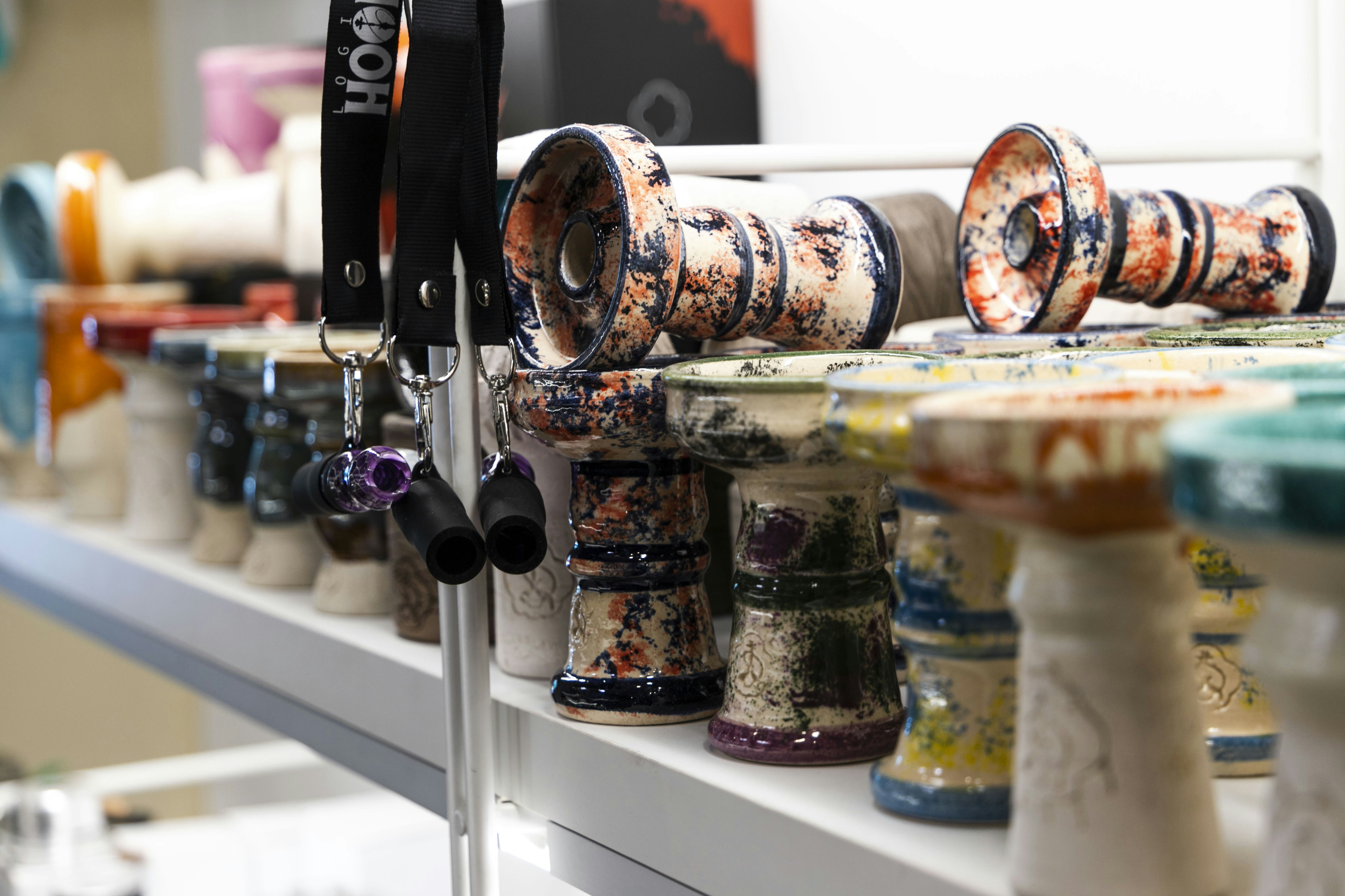 a row of vases sitting on top of a shelf