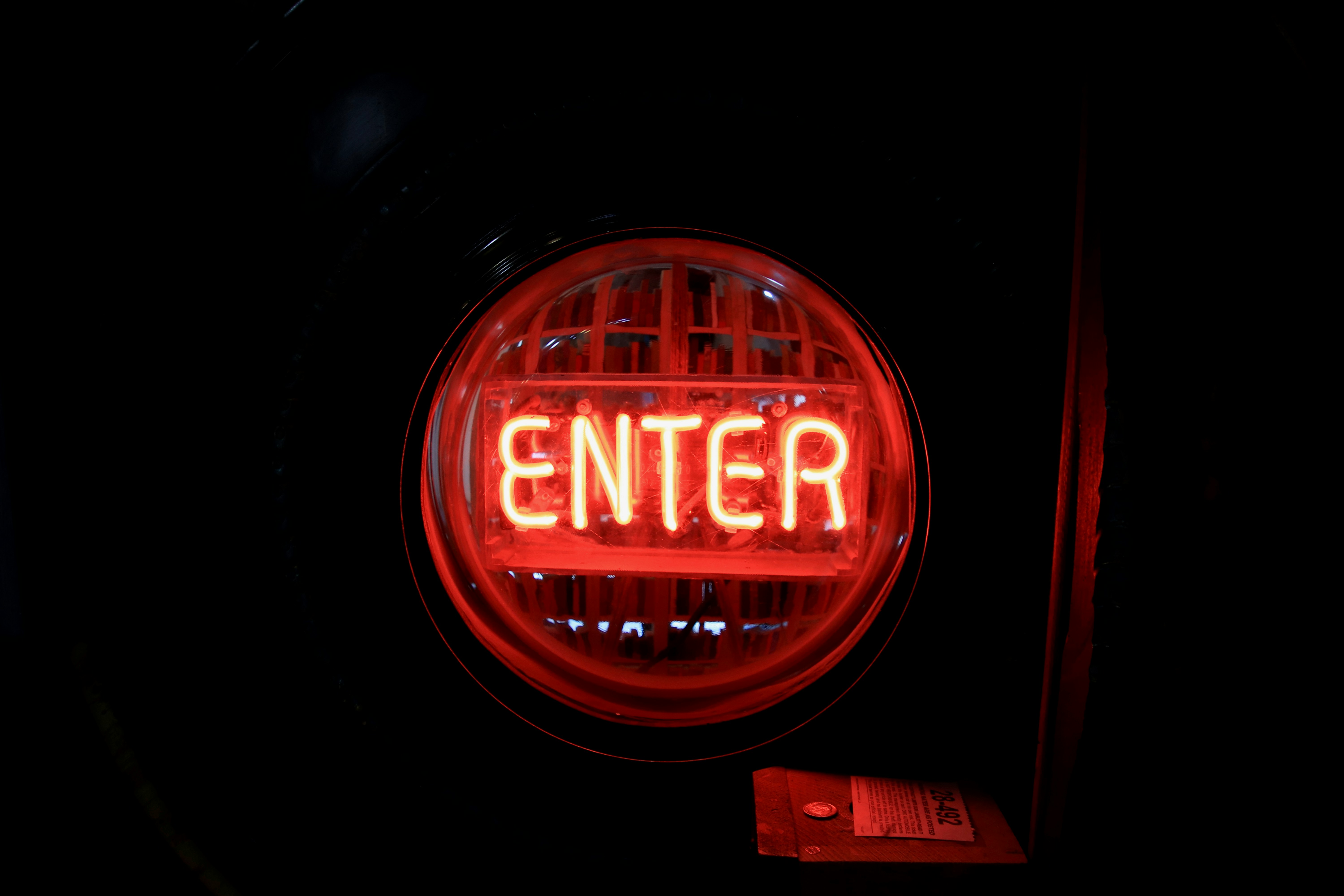 a close up of a red light with the word enter