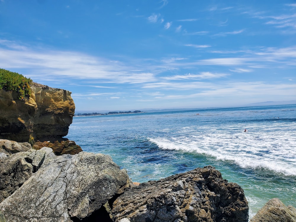 a view of the ocean from a rocky cliff